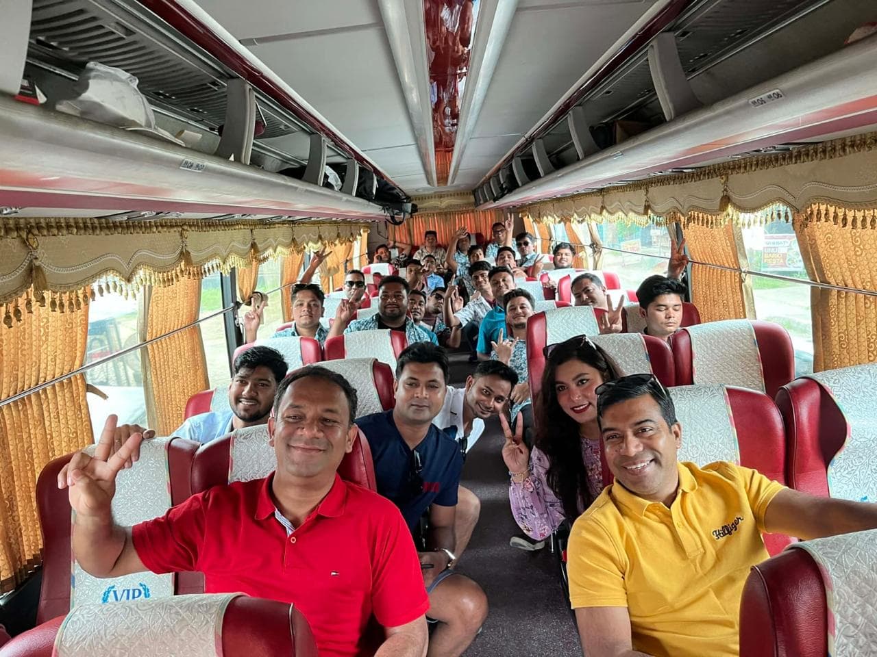 Group from Beacon Pharmaceuticals, Bangladesh smiling and posing together aboard a tour bus during their company trip in the Philippines.